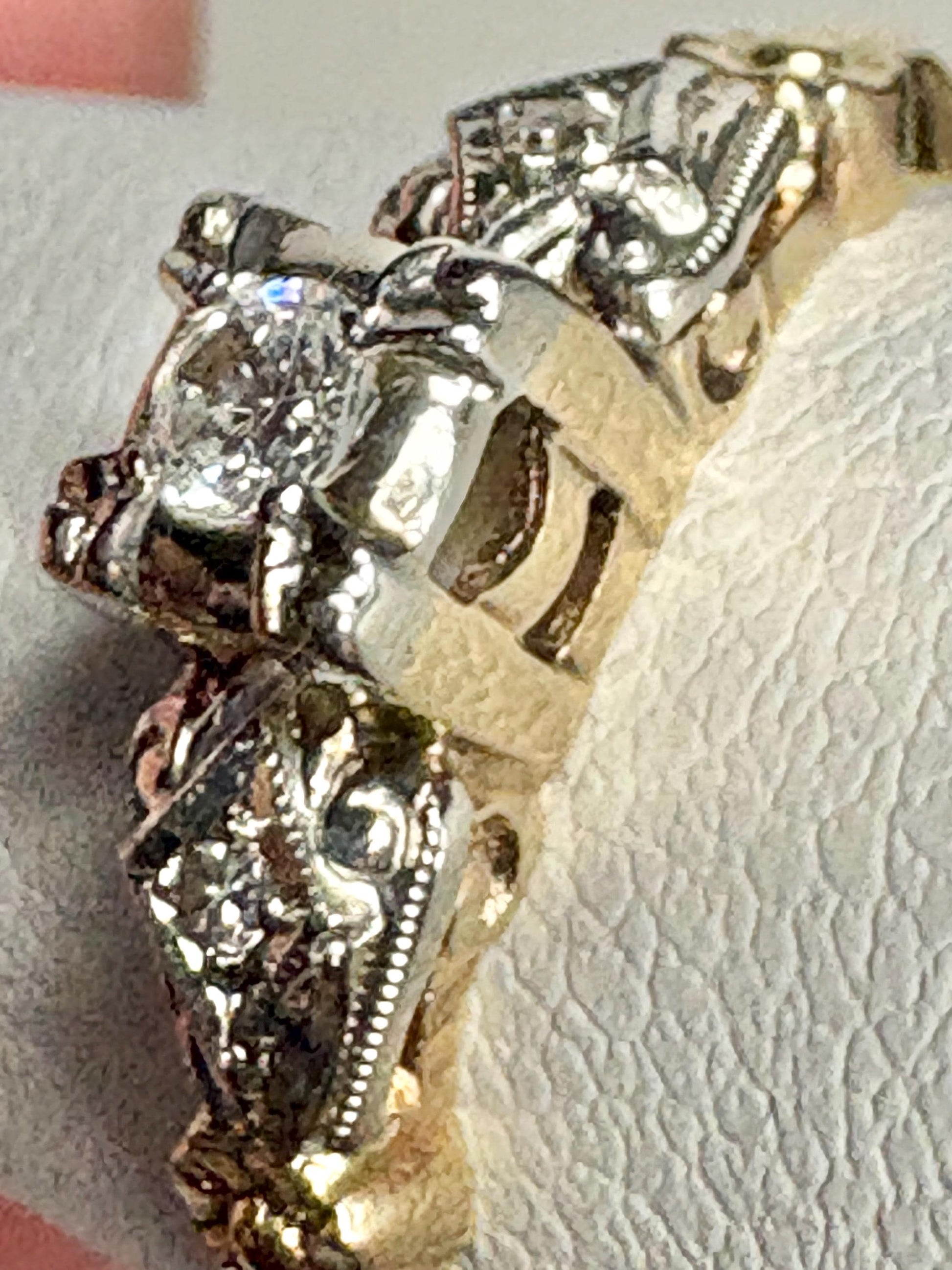 Vintage two-tone 14k gold engagement ring with a central diamond and orange blossom details.