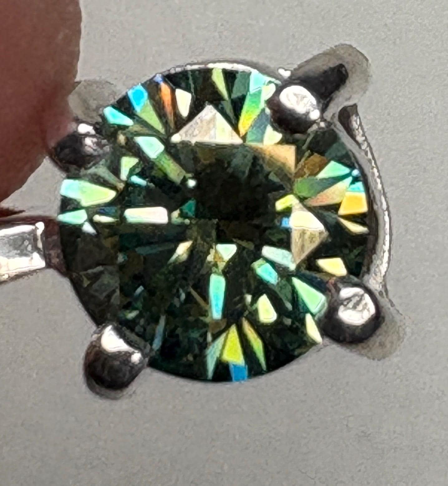 Teal-green moissanite solitaire pendant necklace in sterling silver.