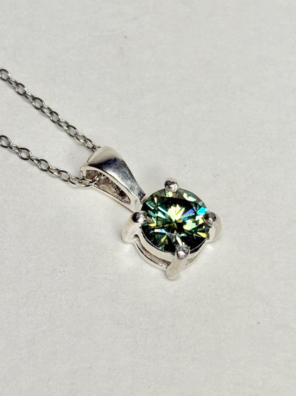 Teal-green moissanite solitaire pendant necklace in sterling silver.