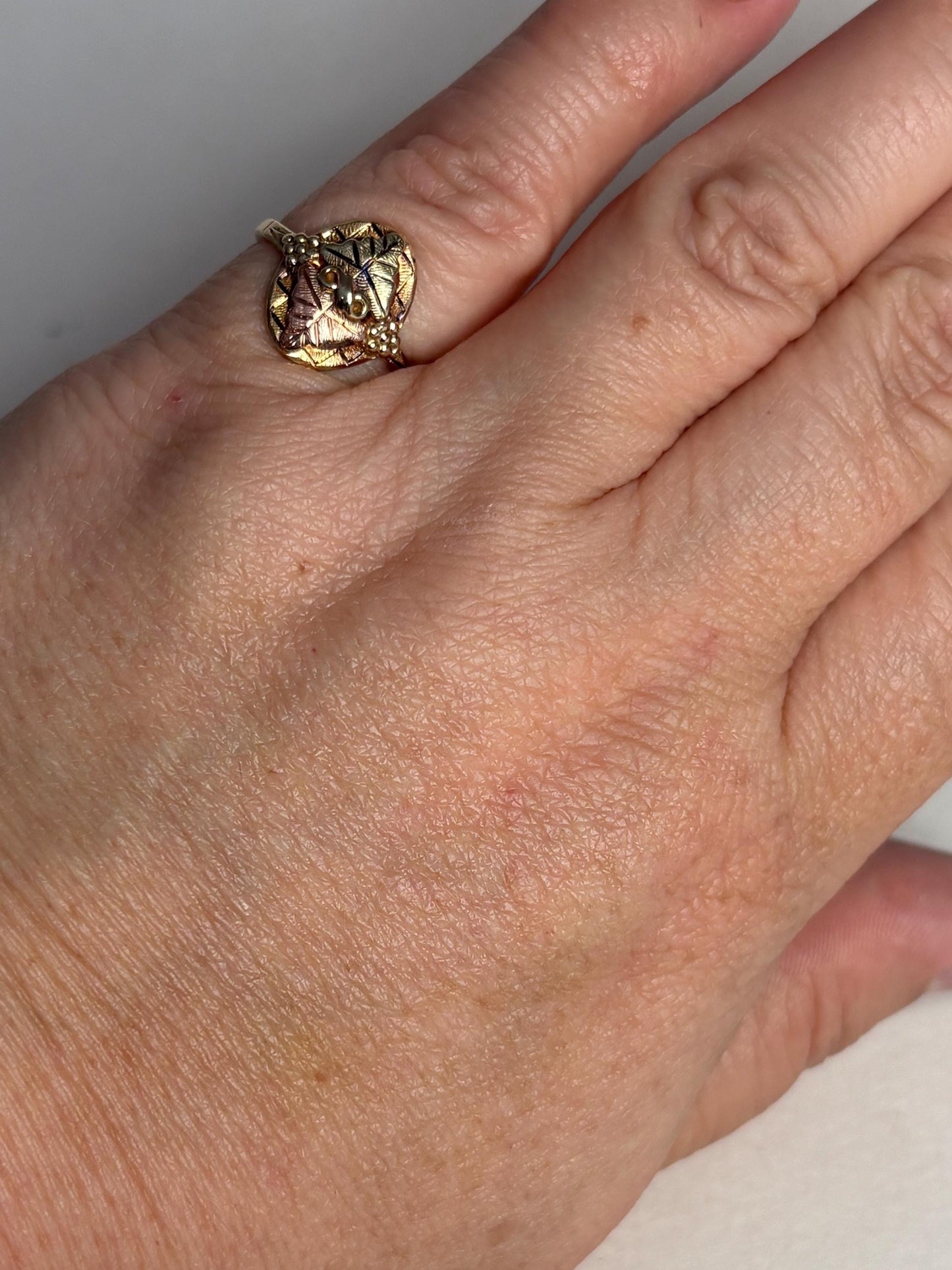 Black Hills Gold ring with two 12k gold leaves on a 10k gold band.
