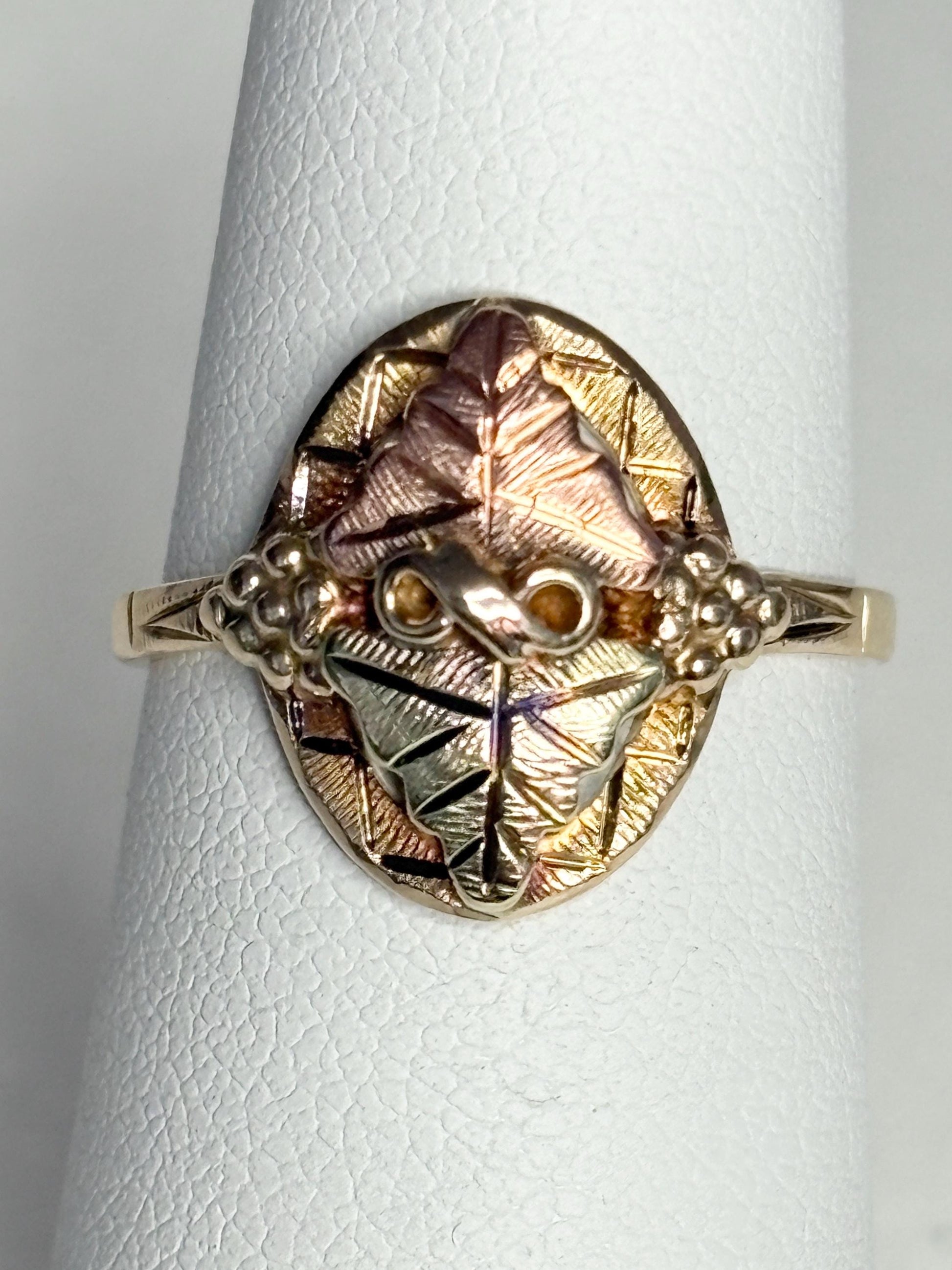 Black Hills Gold ring with 10k gold band and 12k gold leaves.