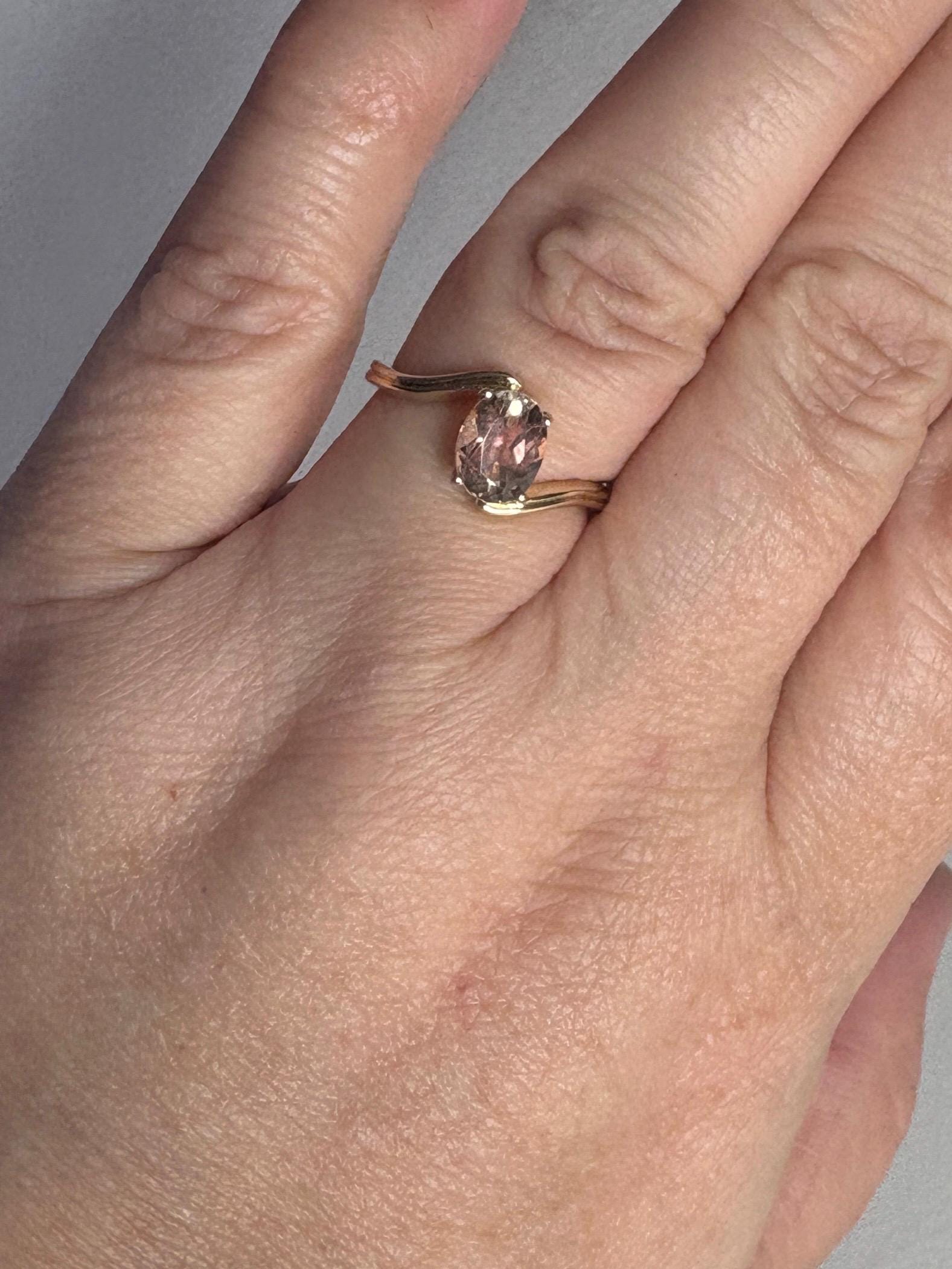 14k gold ring with a light peach oval Oregon sunstone.