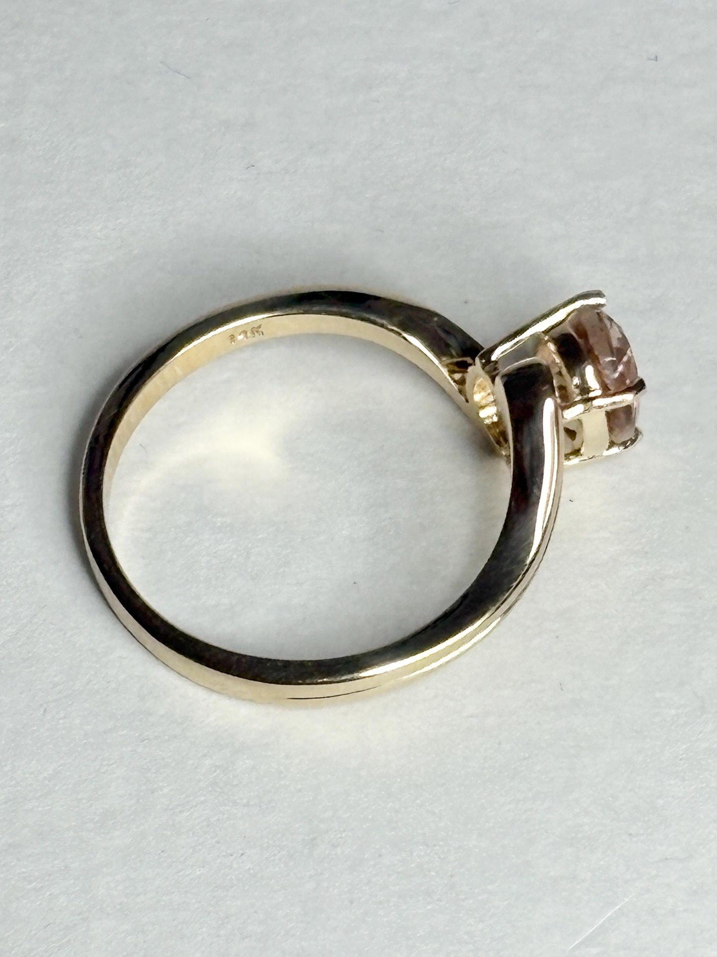 A 14k gold bypass ring with a light peach Oregon sunstone.