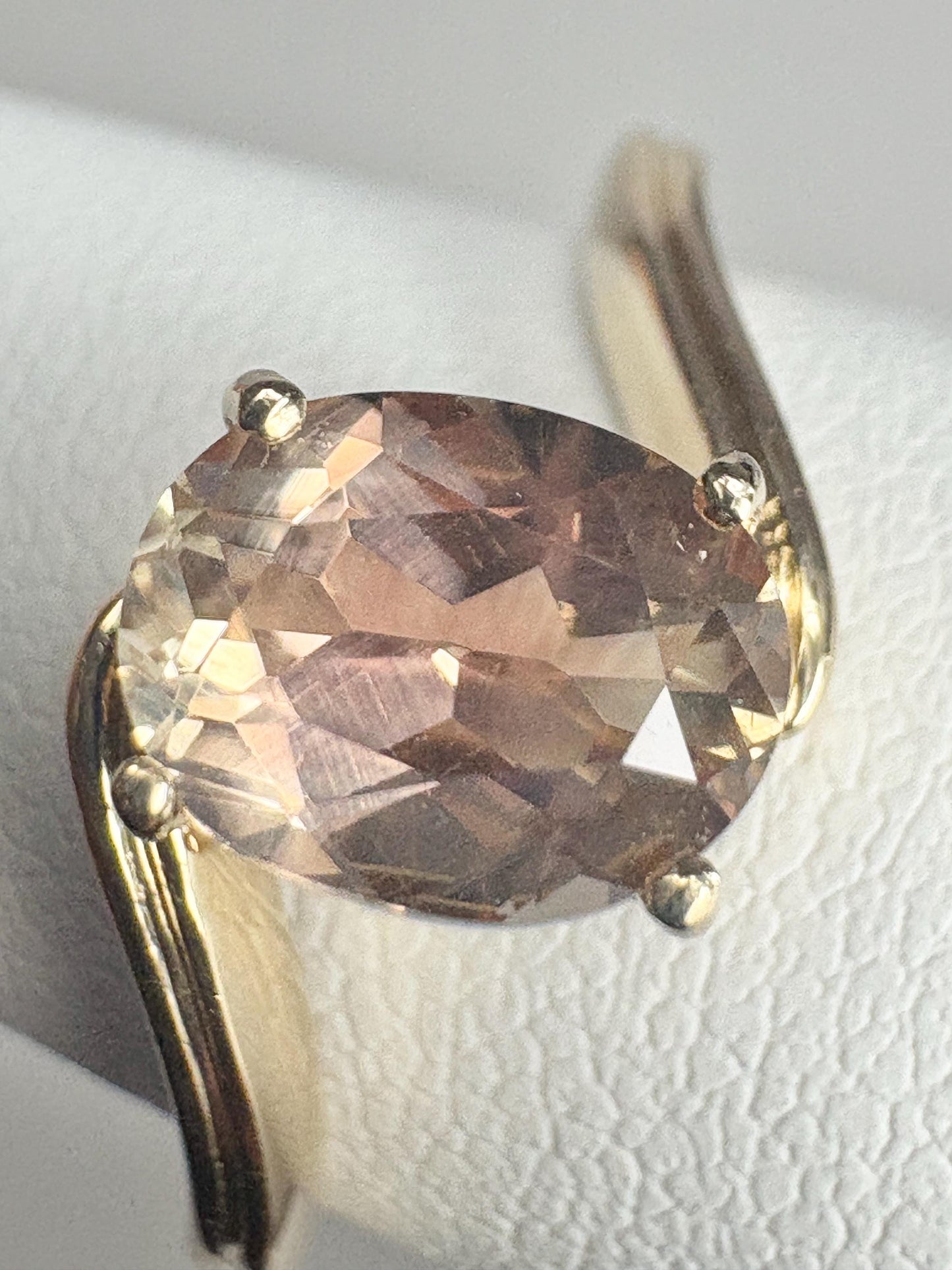 Oval light peach and golden bicolor Oregon sunstone solitaire bypass ring in 14k gold.