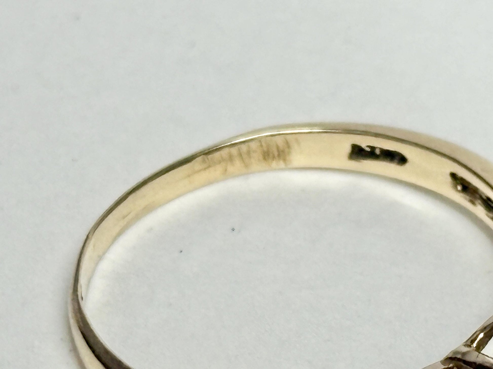 A solid 10k yellow gold ring with a mystic topaz and diamond heart design.