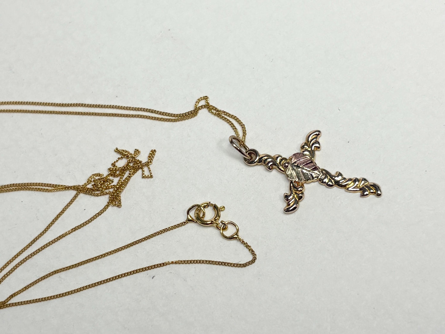 Black Hills Gold cross pendant on an 18-inch 9k gold chain.