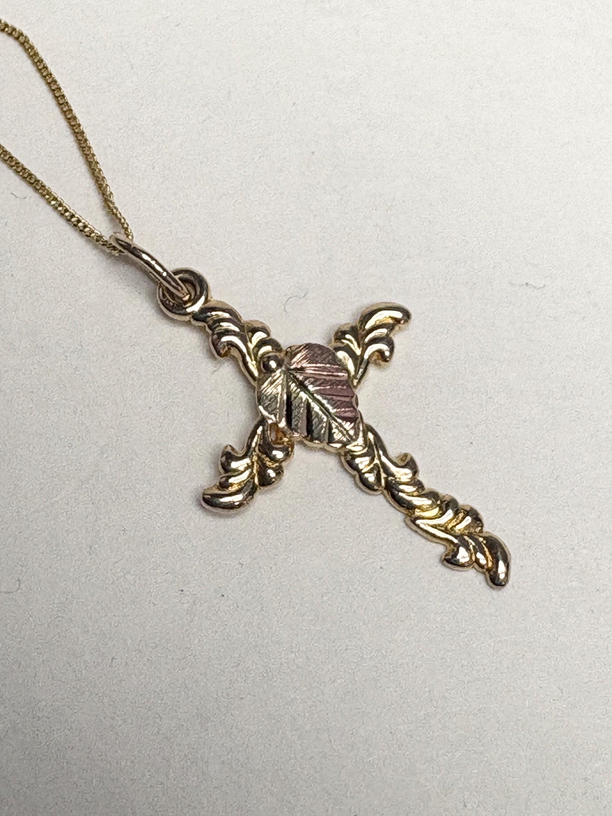 Black Hills Gold 10k gold cross pendant on an 18" 9k gold chain.