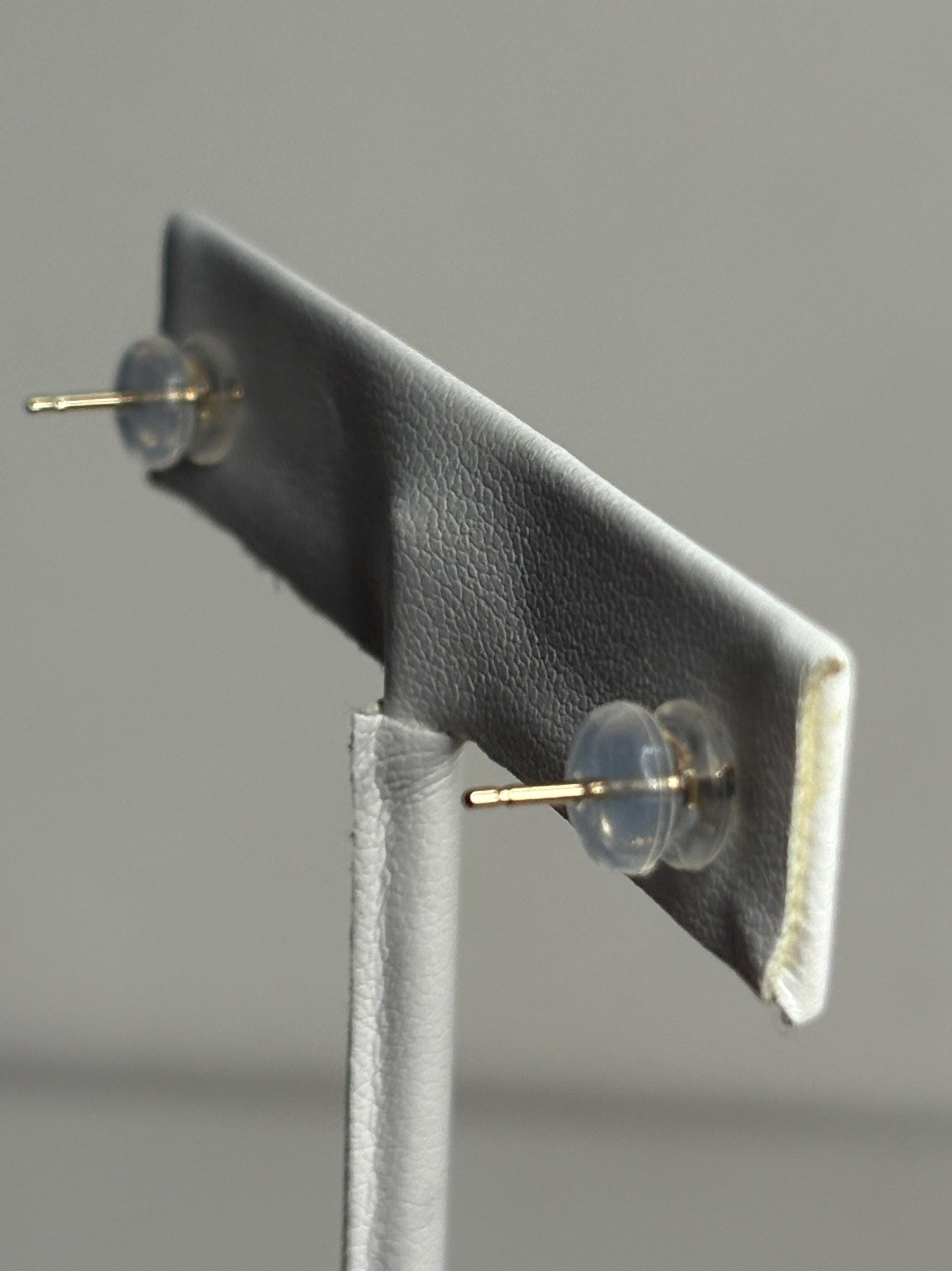 Solid 14k gold daisy stud earrings with orange and yellow enamel.