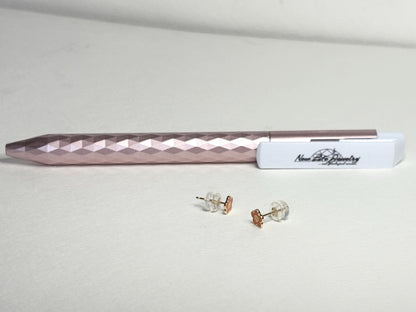 Solid 14k gold daisy stud earrings with orange and yellow enamel.