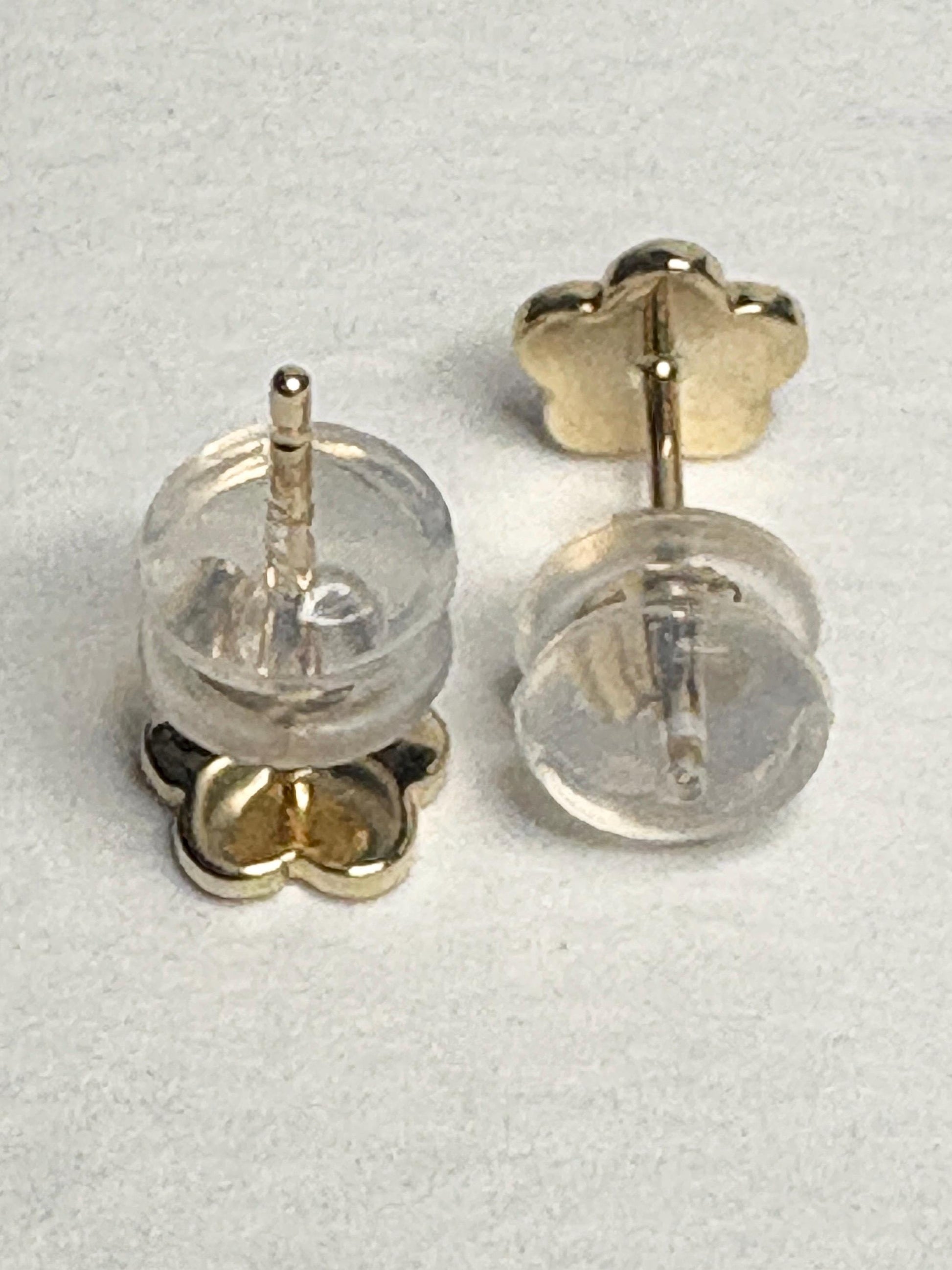 Solid 14k gold daisy flower stud earrings with orange and yellow enamel.