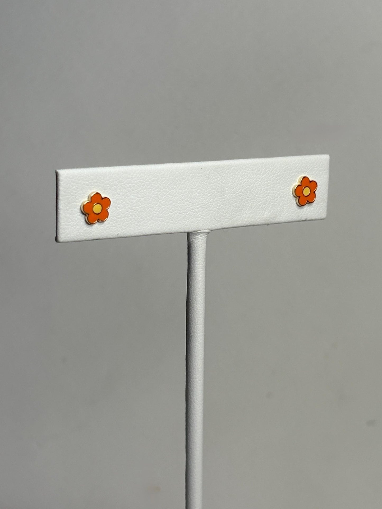 14k gold stud earrings with orange and yellow enamel daisy flower design.