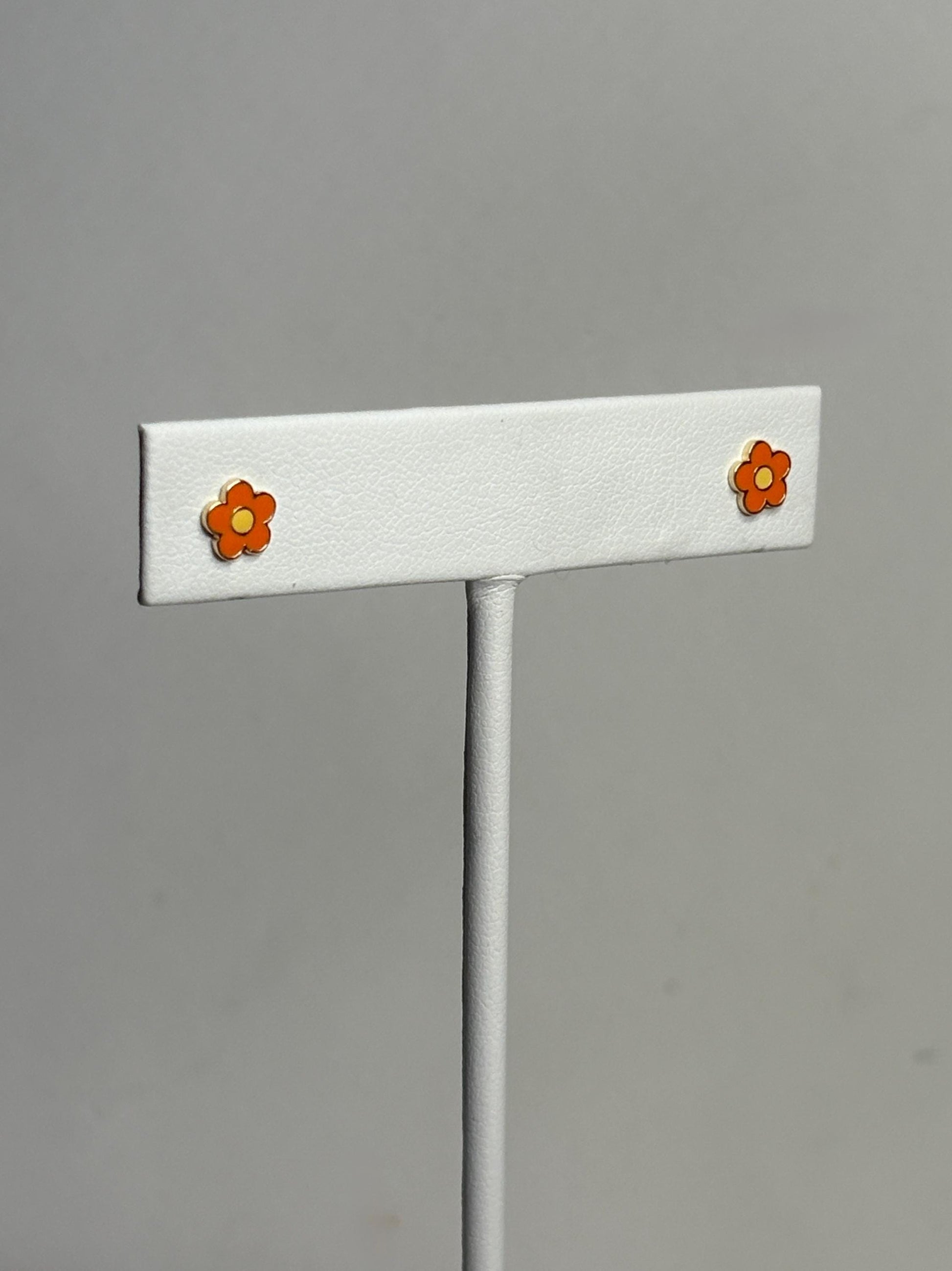 14k gold stud earrings with orange and yellow enamel daisy flower design.