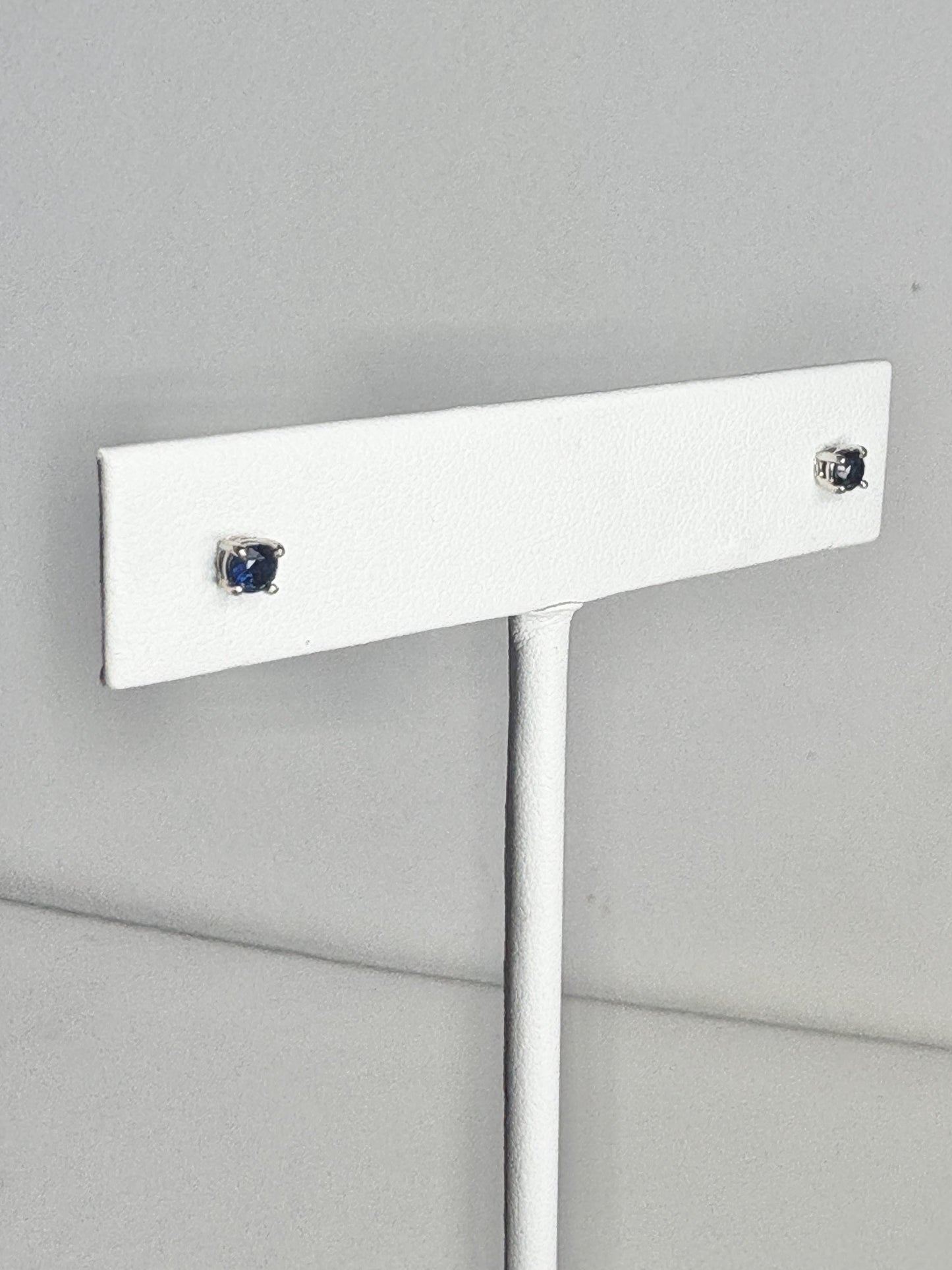 Natural dark blue sapphire stud earrings in solid 14k white gold.