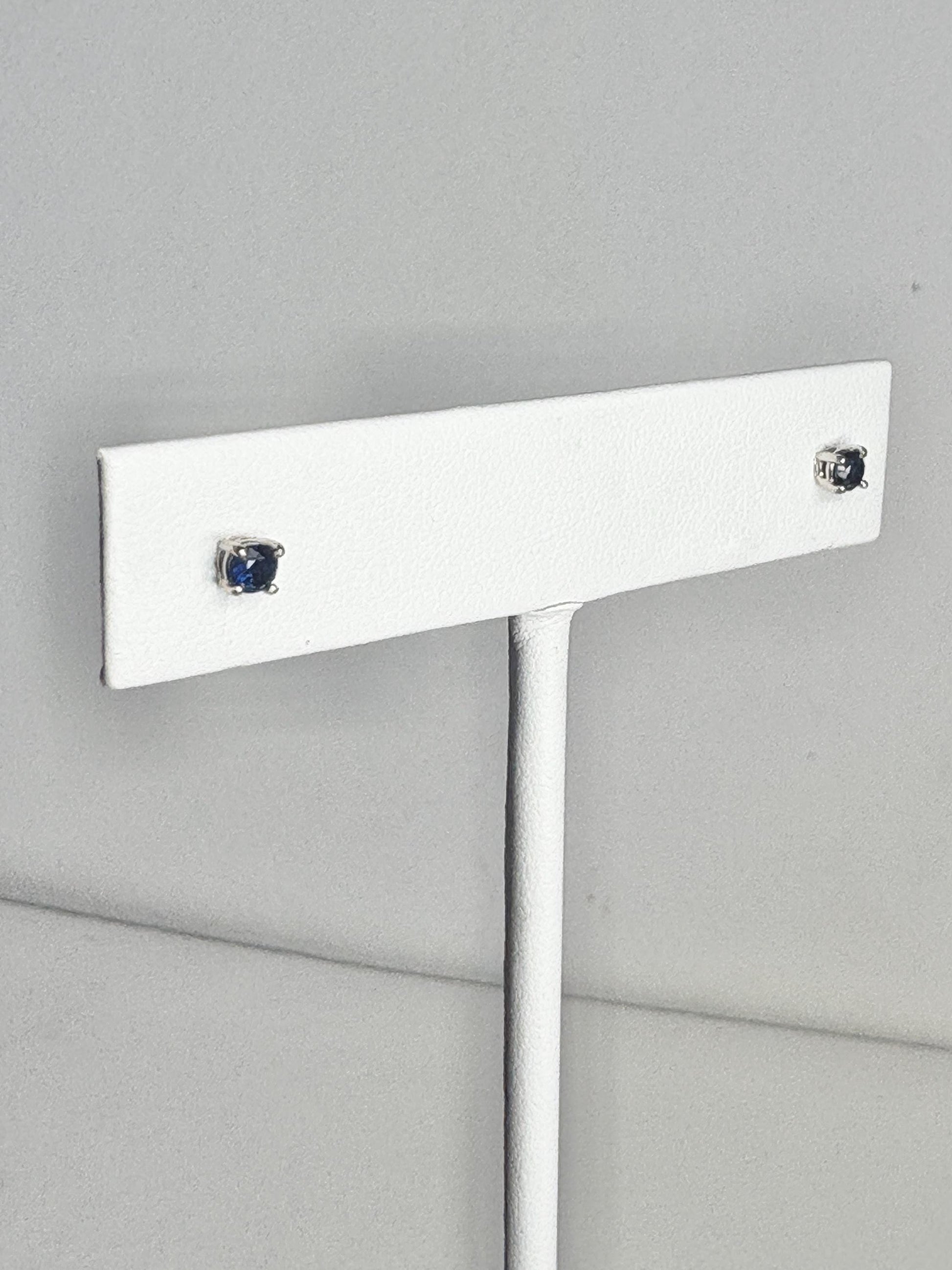 Natural dark blue sapphire stud earrings in solid 14k white gold.