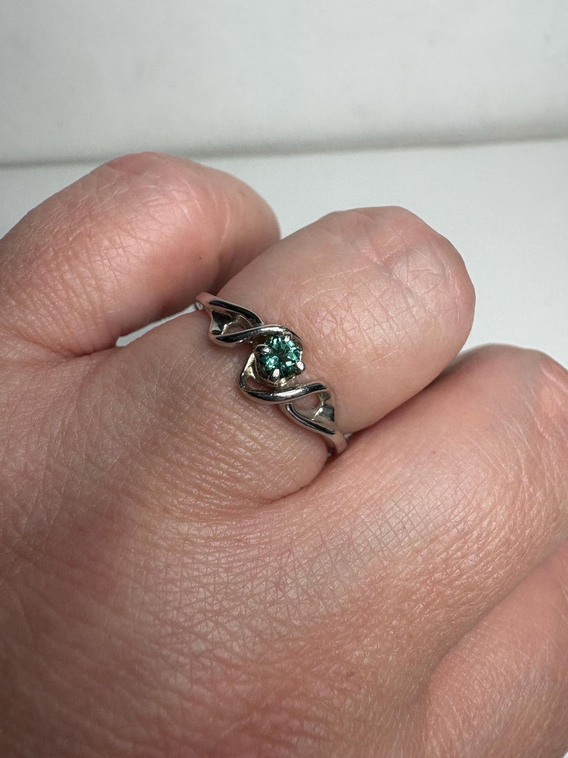 Lagoon blue-green tourmaline band ring in 10k white gold.