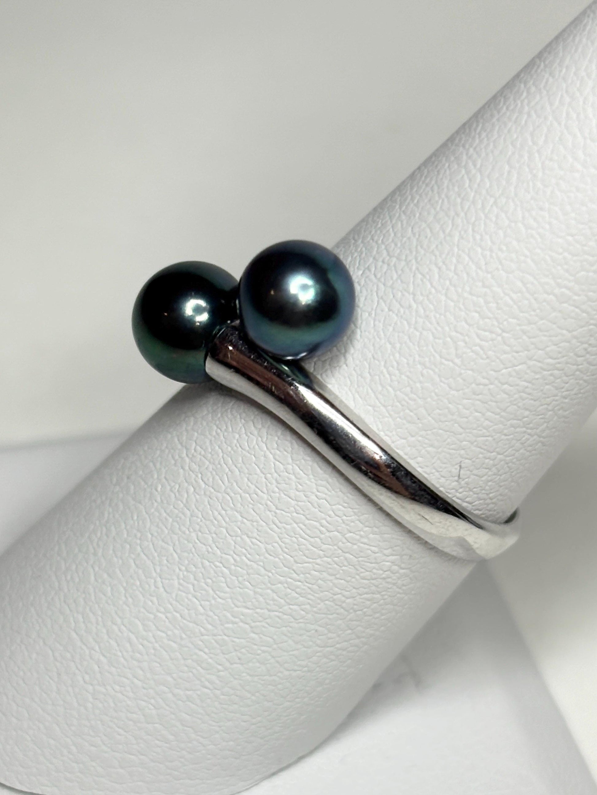 Sterling silver bypass ring with two black cultured Akoya pearls.