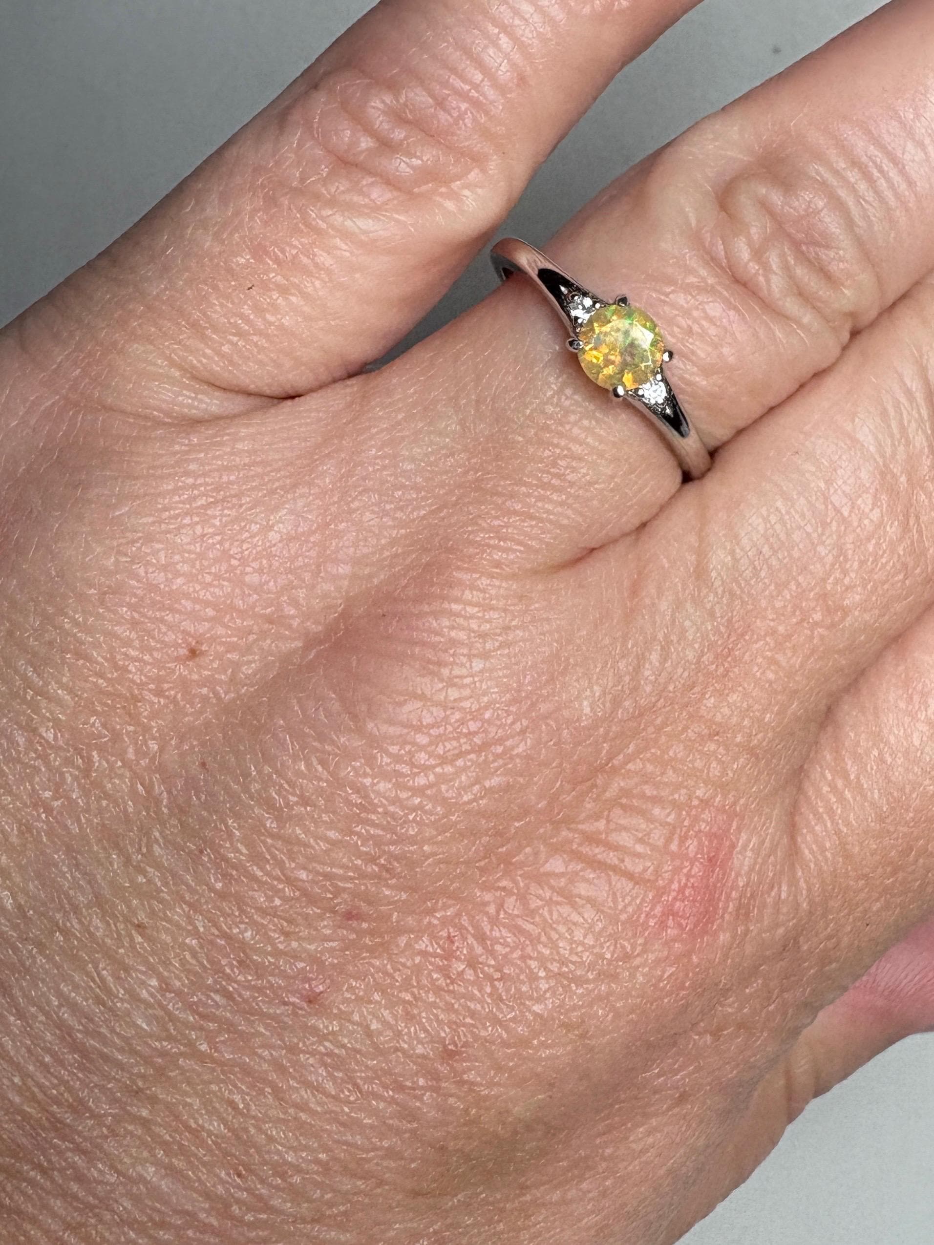 Sterling silver ring with a golden Ethiopian opal and two small diamonds.