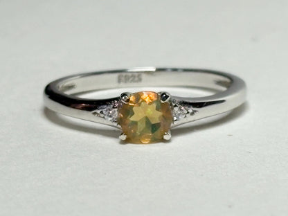 Sterling silver ring with a golden Ethiopian opal and two small diamonds.