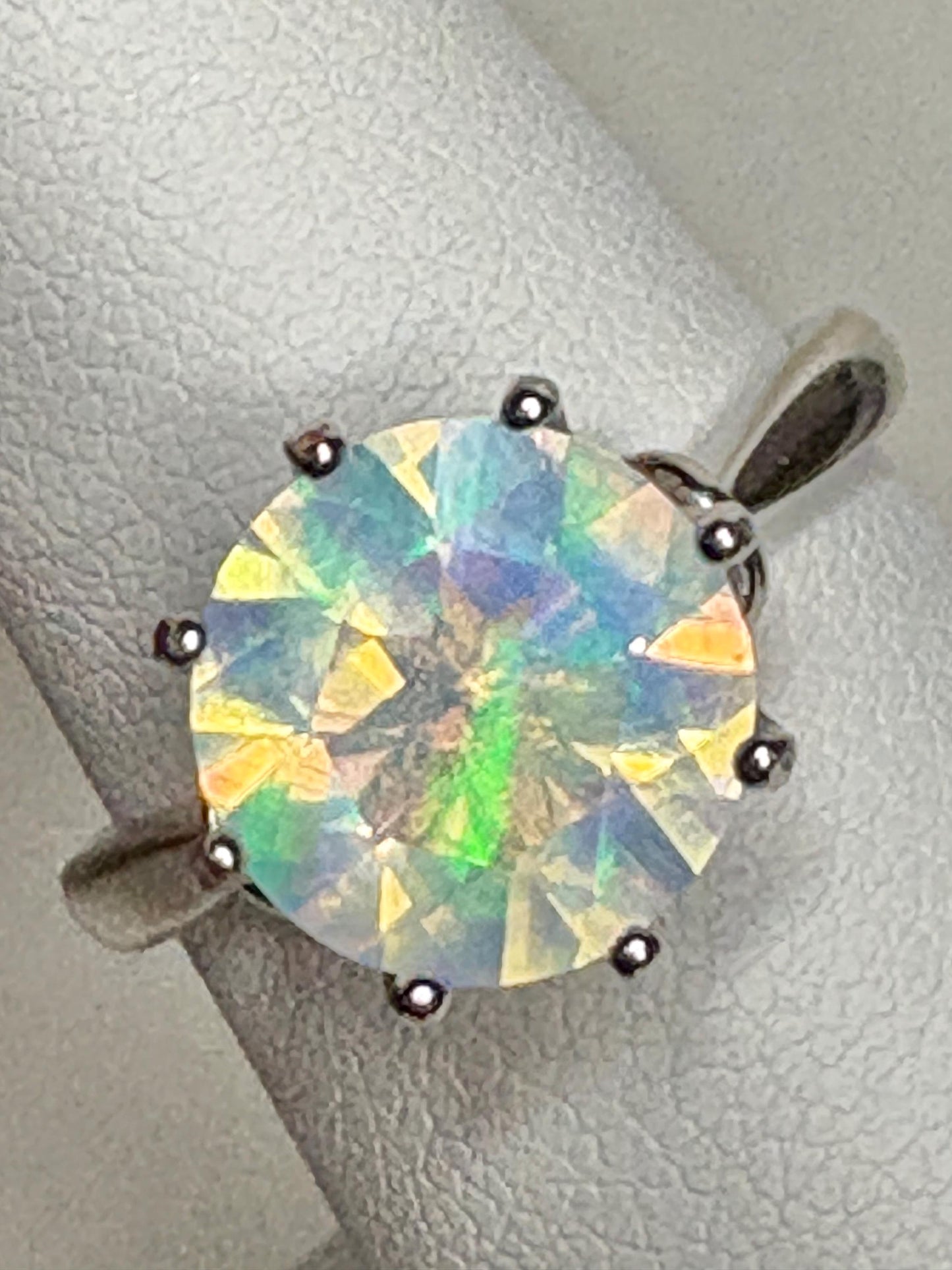 A faceted crystal opal ring in sterling silver.