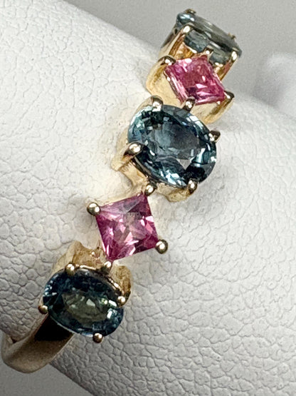 9k gold band ring with oval steel blue and square pink sapphires.
