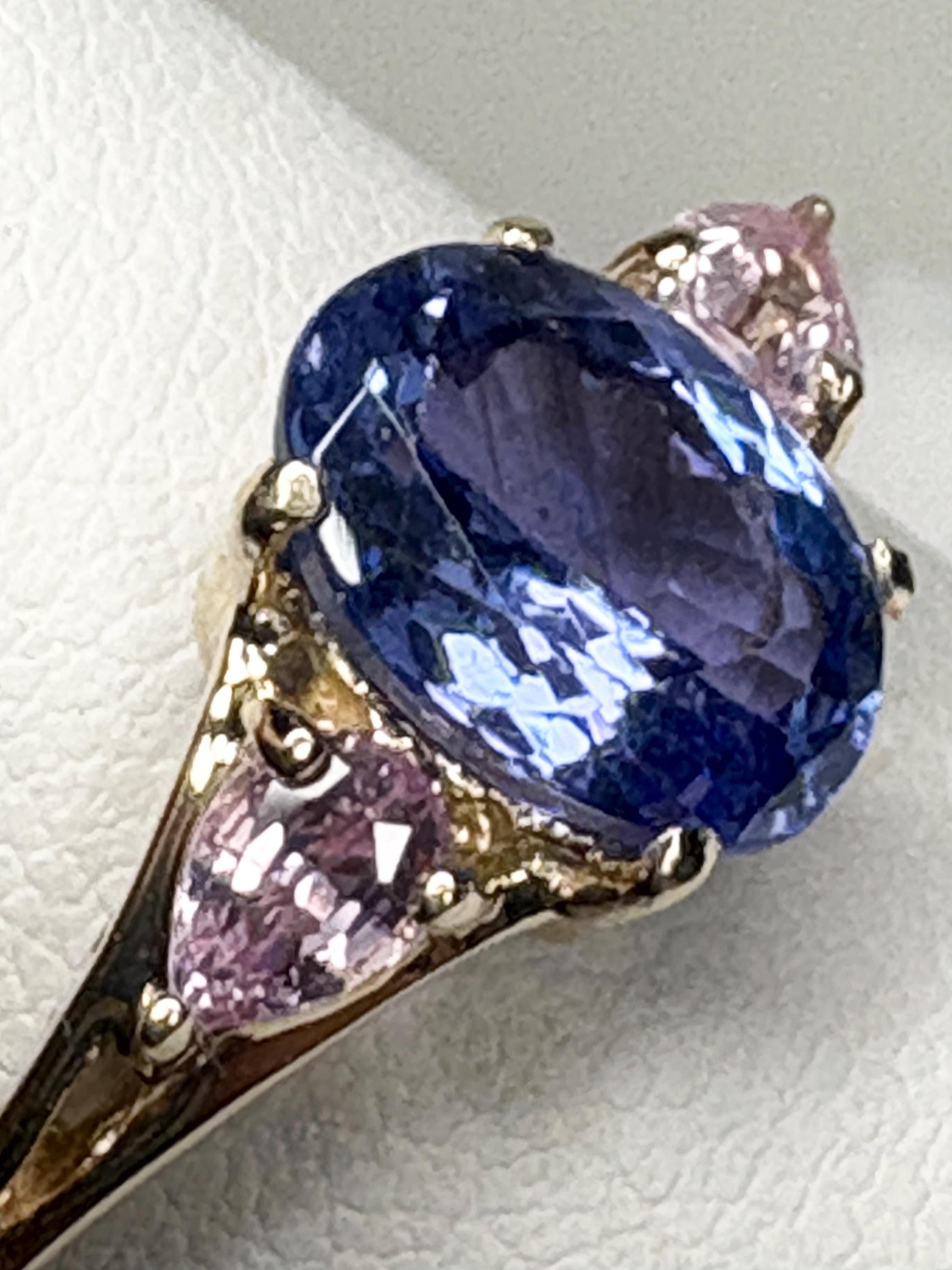 Oval tanzanite and pear pink sapphire ring in 9k gold.