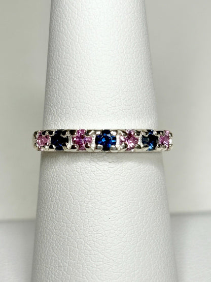 Sterling silver band ring with alternating blue and pink sapphires.