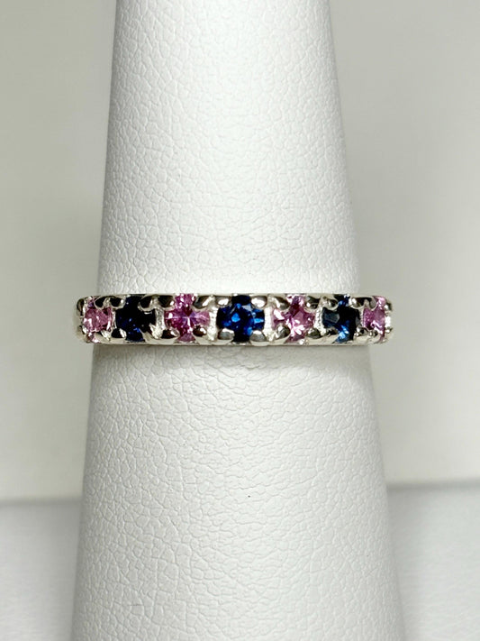 Sterling silver band ring with alternating blue and pink sapphires.