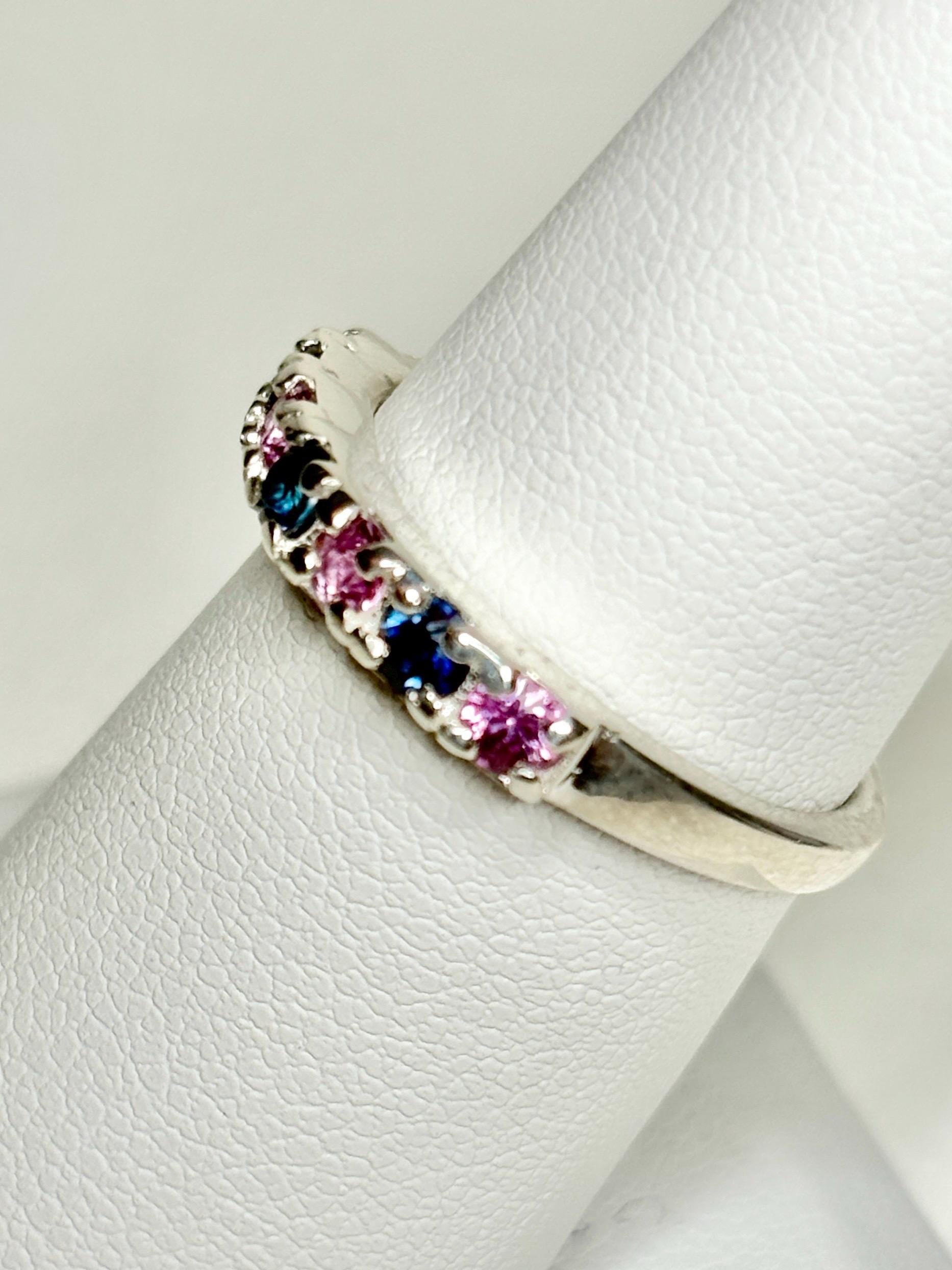 Sterling silver band ring with alternating blue and pink sapphires.