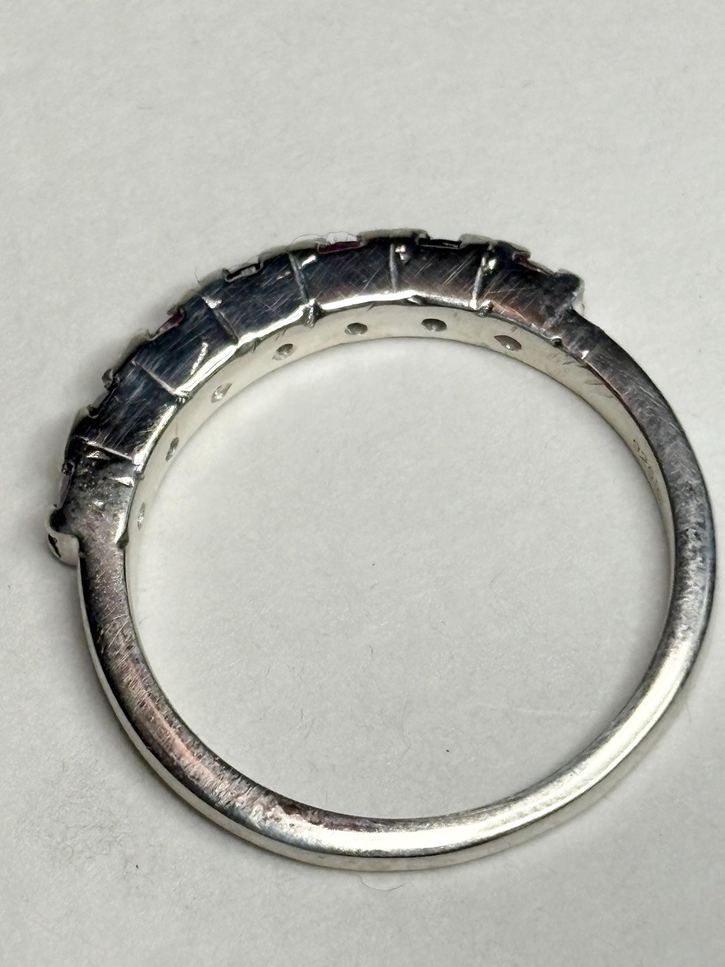 Sterling silver stackable band ring with alternating blue and pink sapphires.