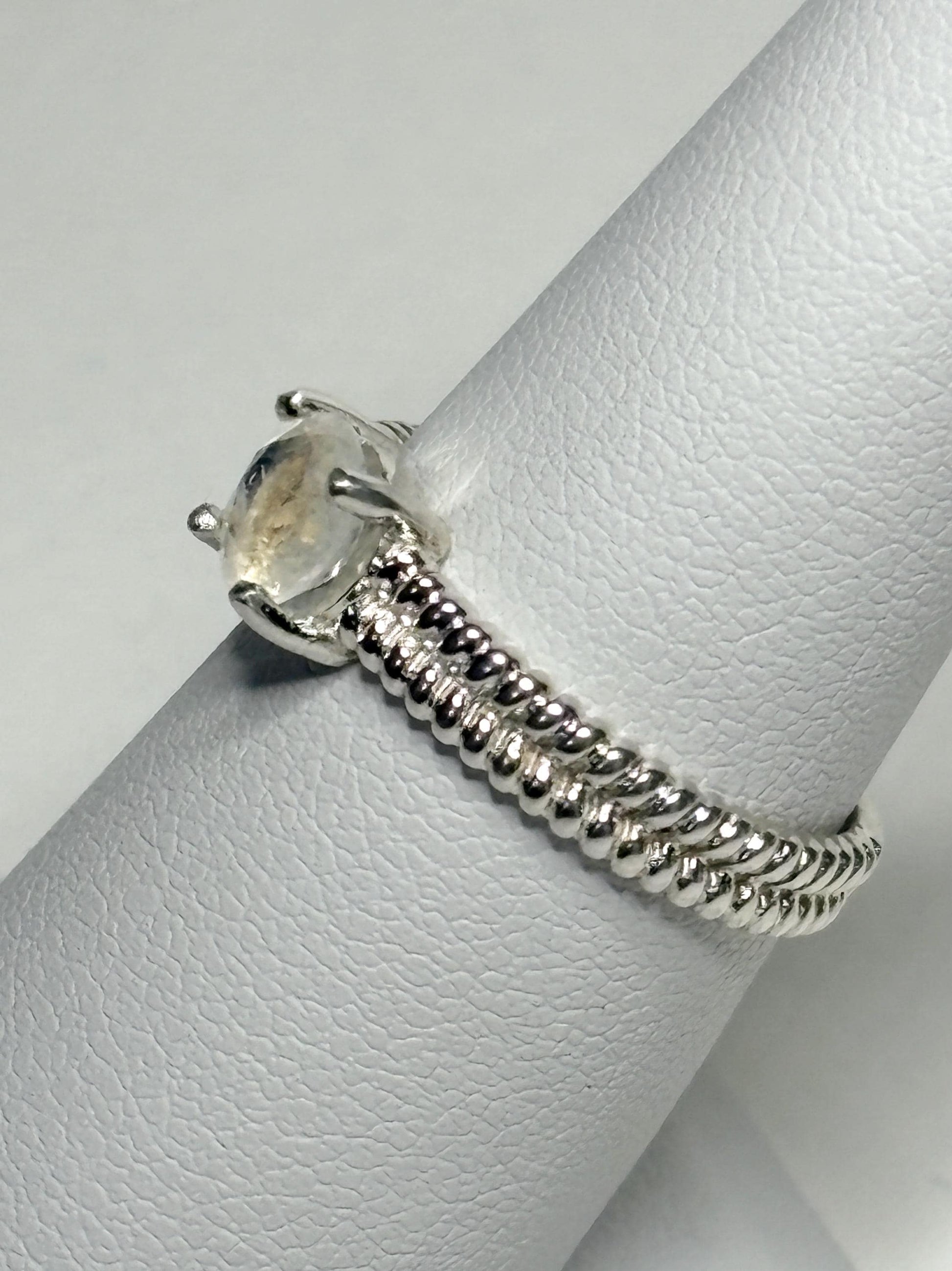 Sterling silver ring with a rainbow moonstone and double rope band.