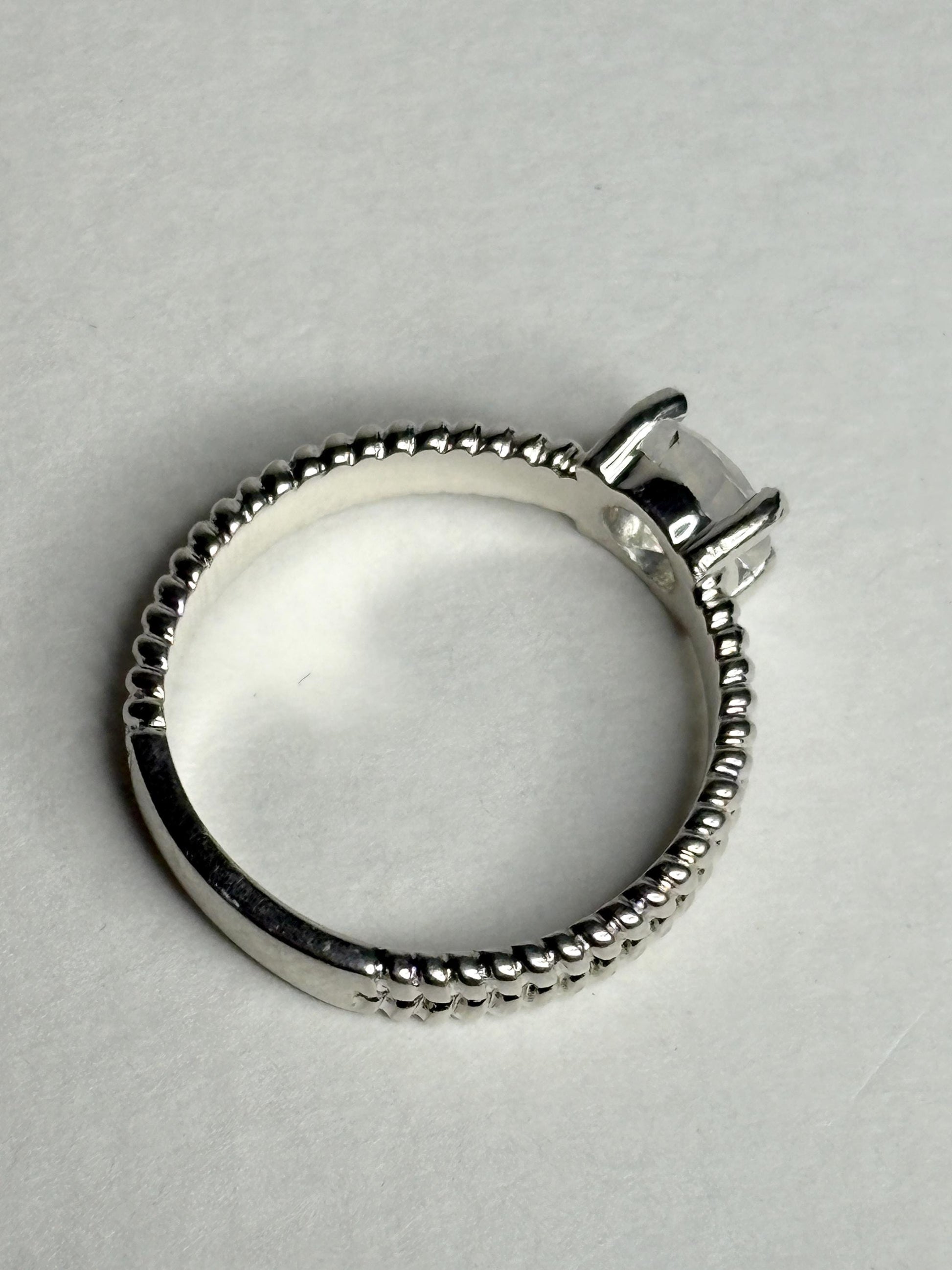 Sterling silver ring with a rainbow moonstone and double rope band.