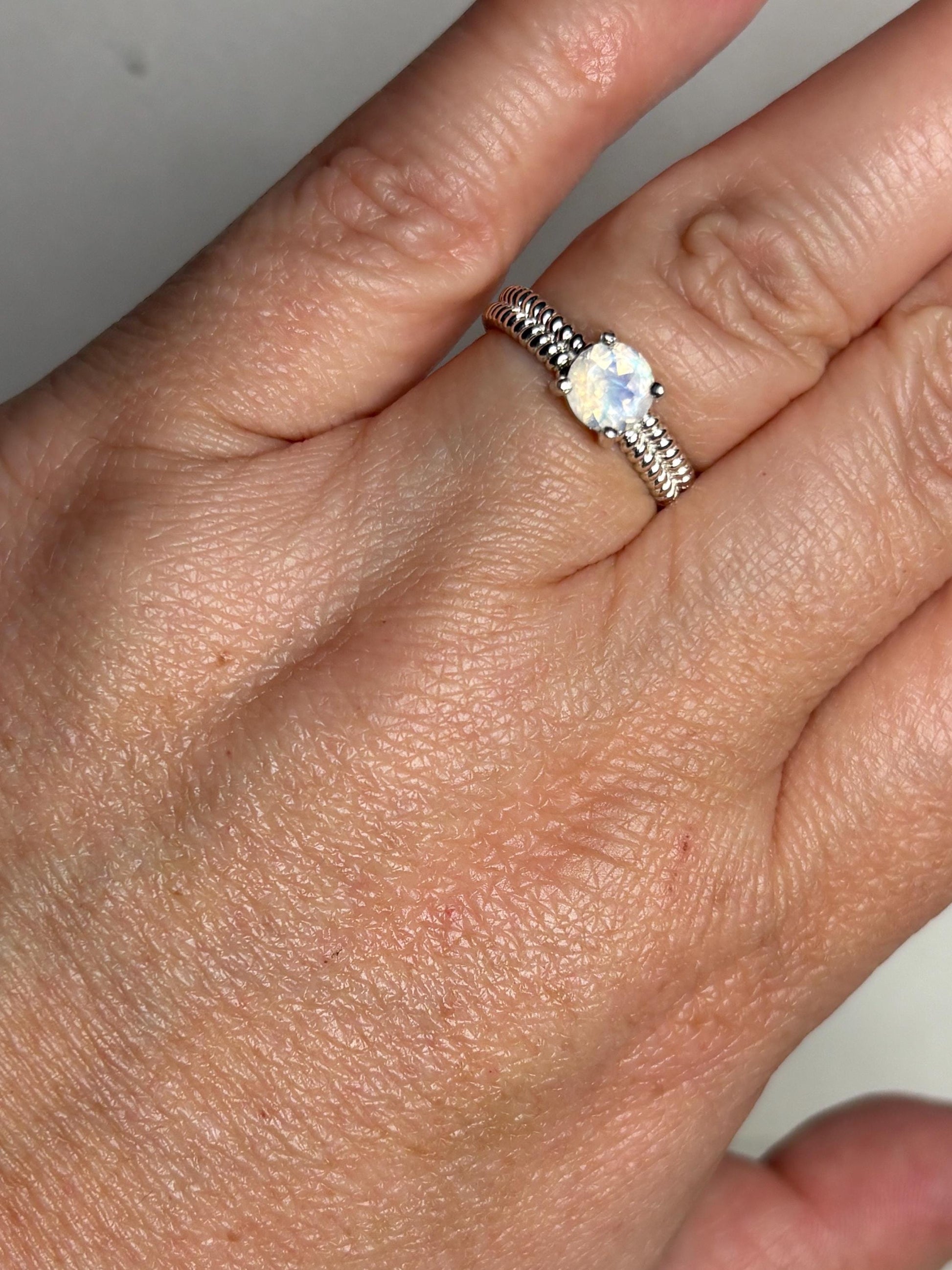 Sterling silver ring with a rainbow moonstone and double rope band.