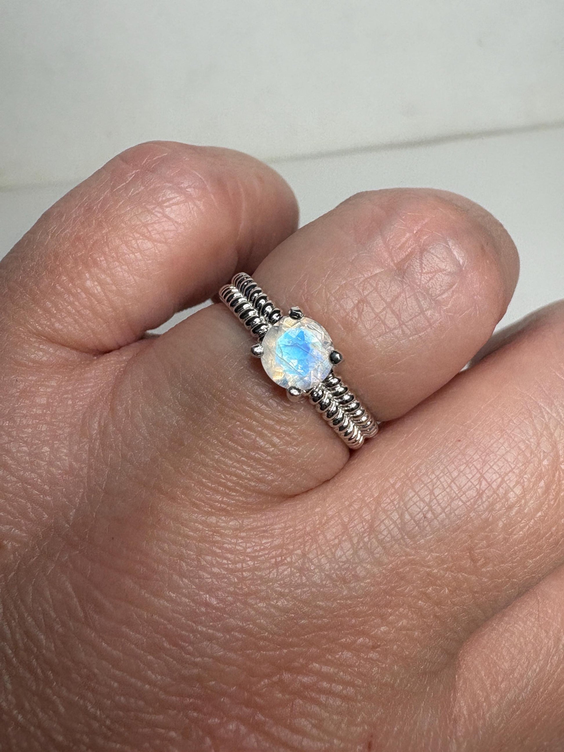Sterling silver ring with a rainbow moonstone solitaire and double rope band.