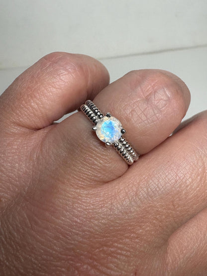 Sterling silver ring with a rainbow moonstone solitaire and double rope band.