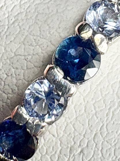 Sterling silver band ring with blue and light blue sapphires.