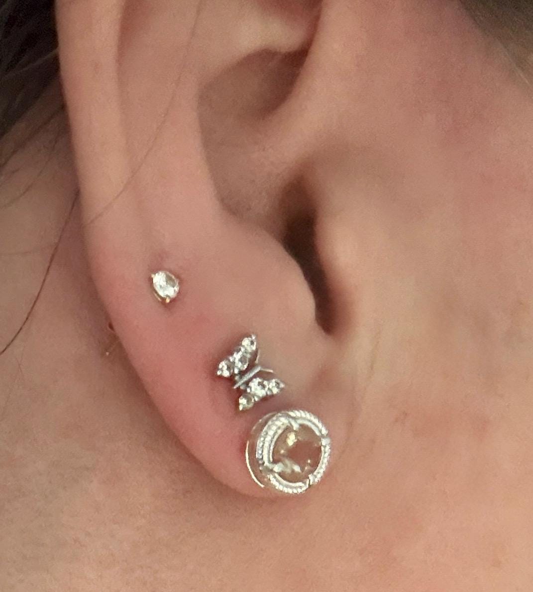 Sterling silver stud earrings with a checkerboard faceted andesine stone and rope design.