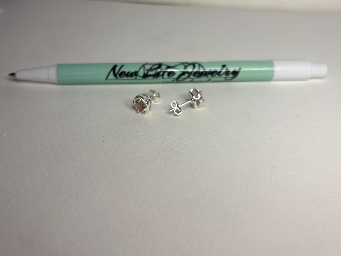 Sterling silver stud earrings with checkerboard faceted andesine gems in a rope design.