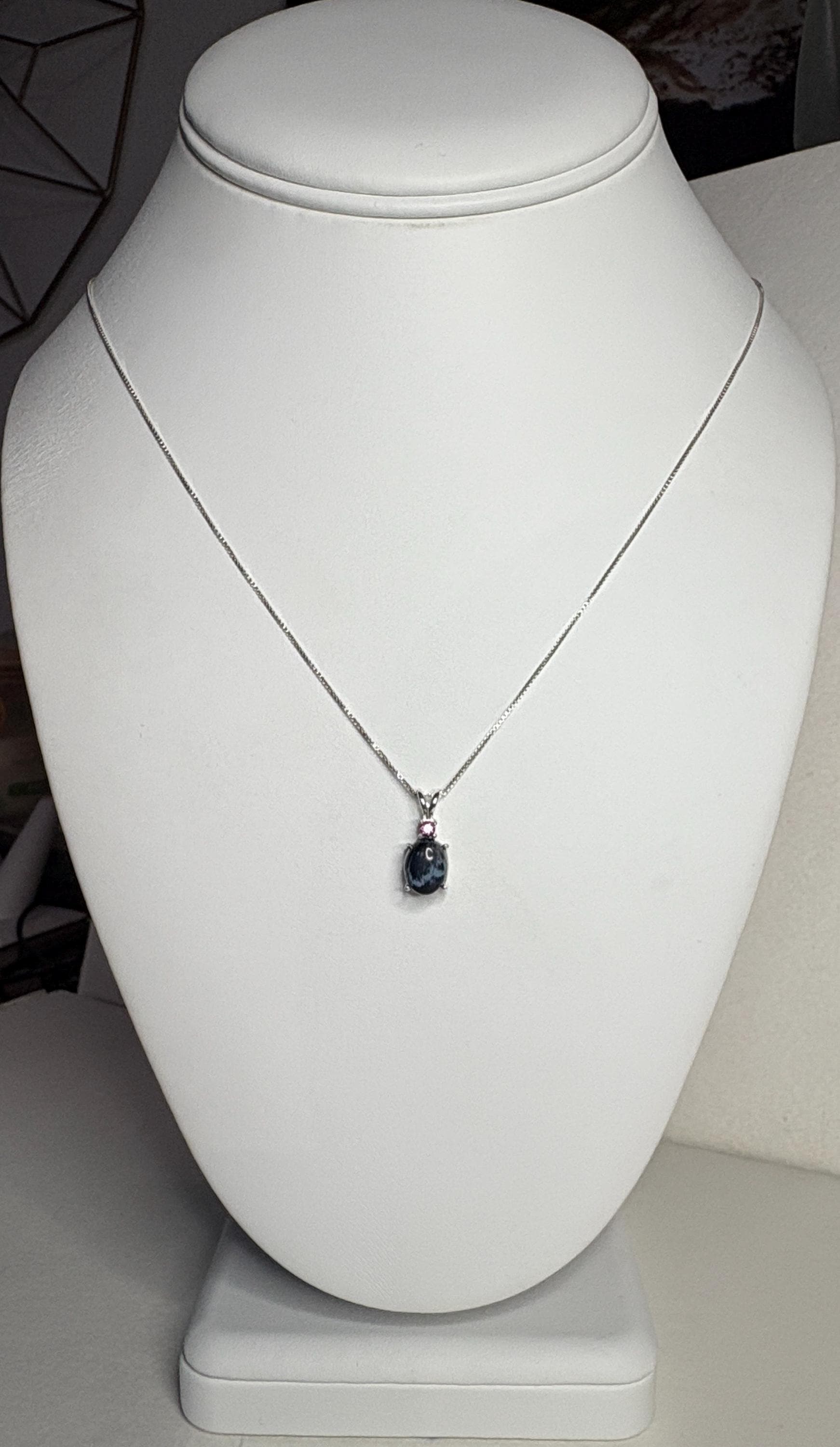 Sterling silver necklace with African blue pietersite and rhodolite garnet pendant.