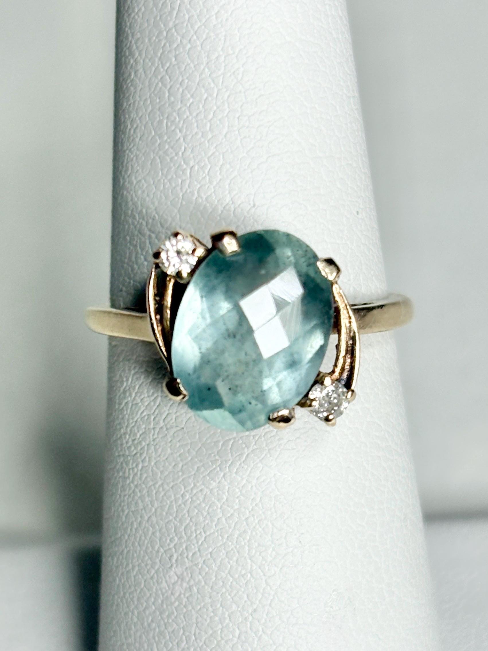 Vintage 10k gold ring with oval seafoam aquamarine and two diamonds.