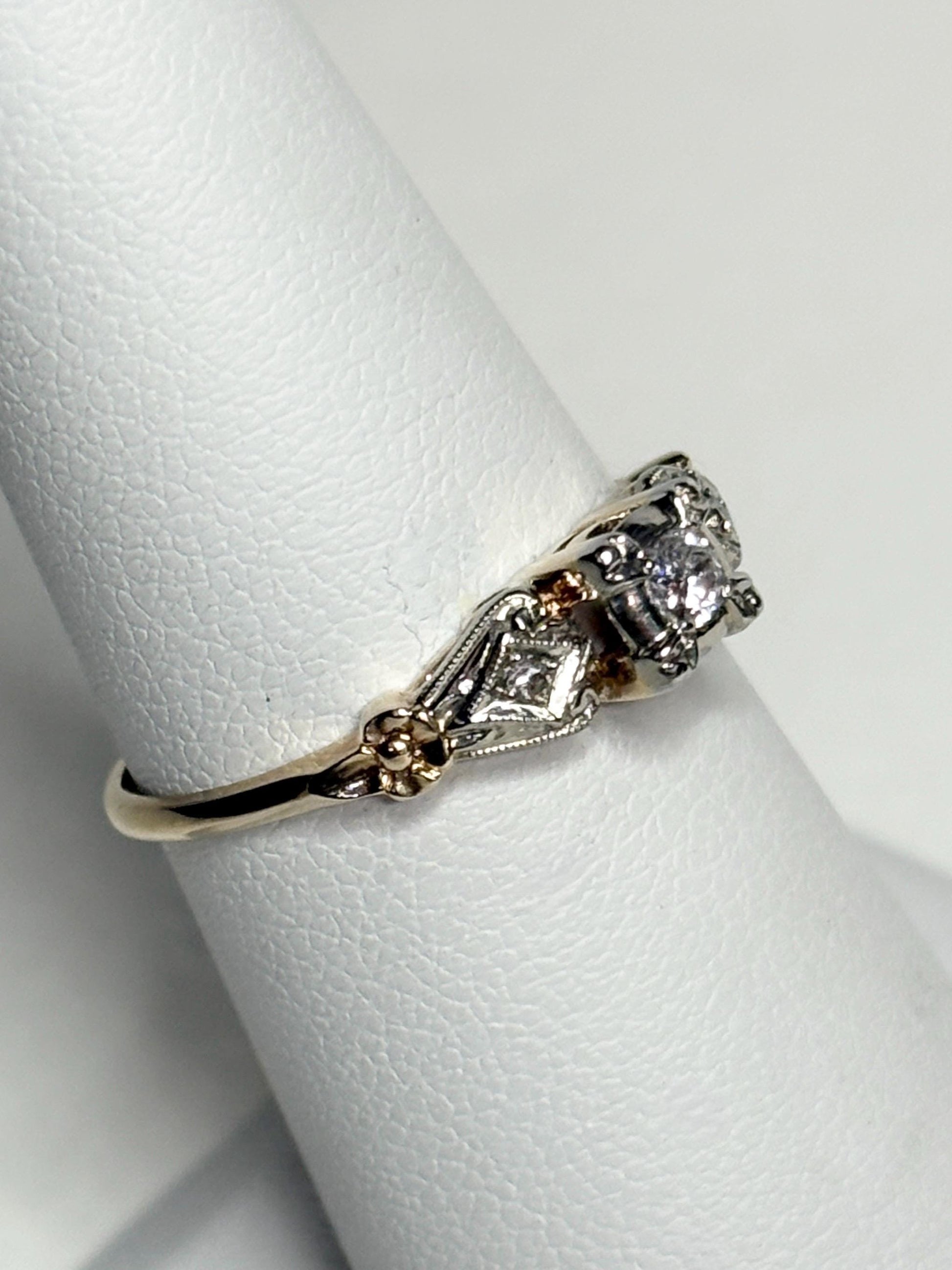 Vintage two-tone 14k gold ring with a central diamond and orange blossom details.