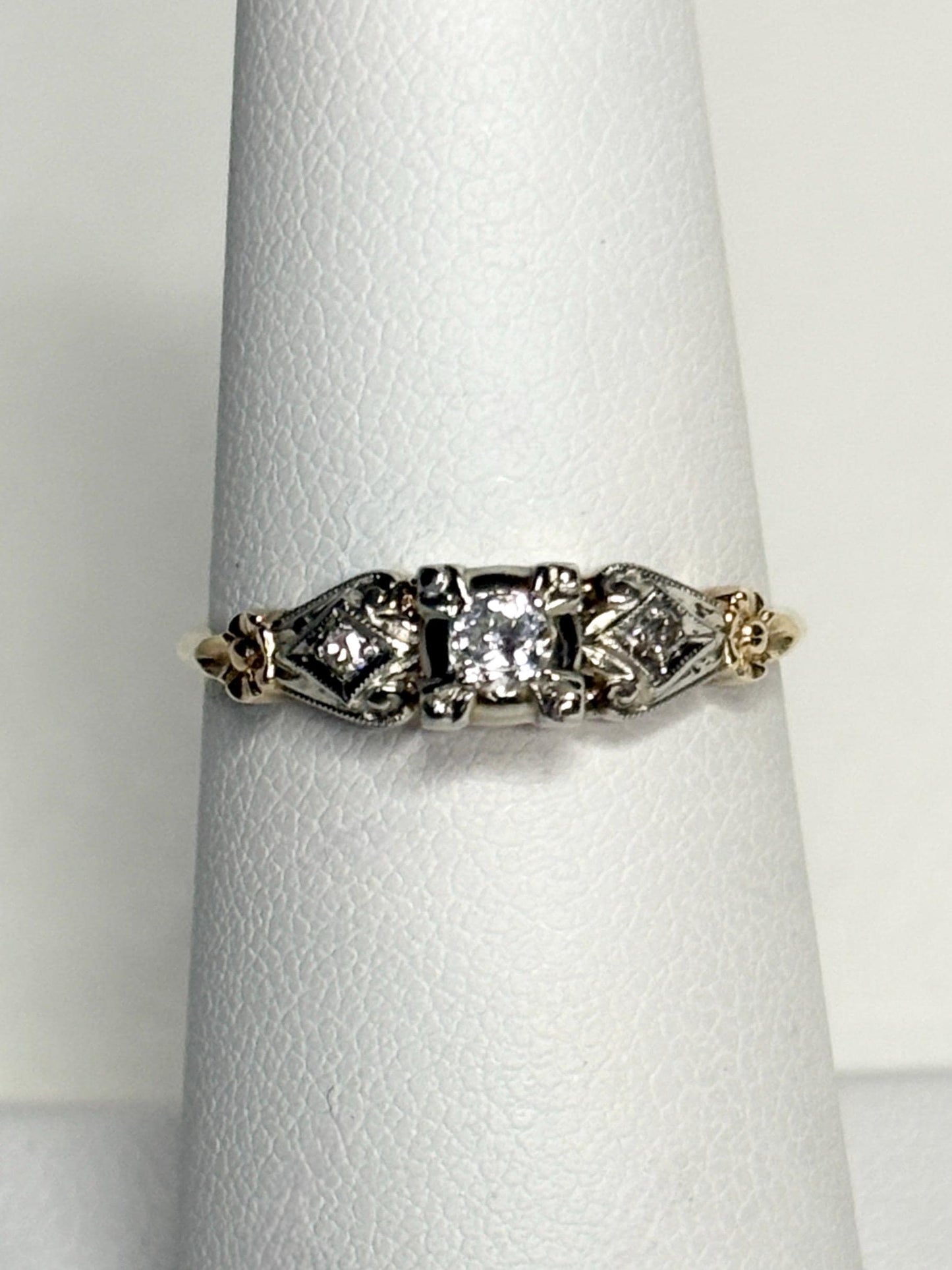 Vintage two-tone 14k gold ring with a central diamond and orange blossom details.
