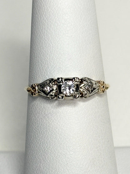 Vintage two-tone 14k gold ring with a central diamond and orange blossom details.