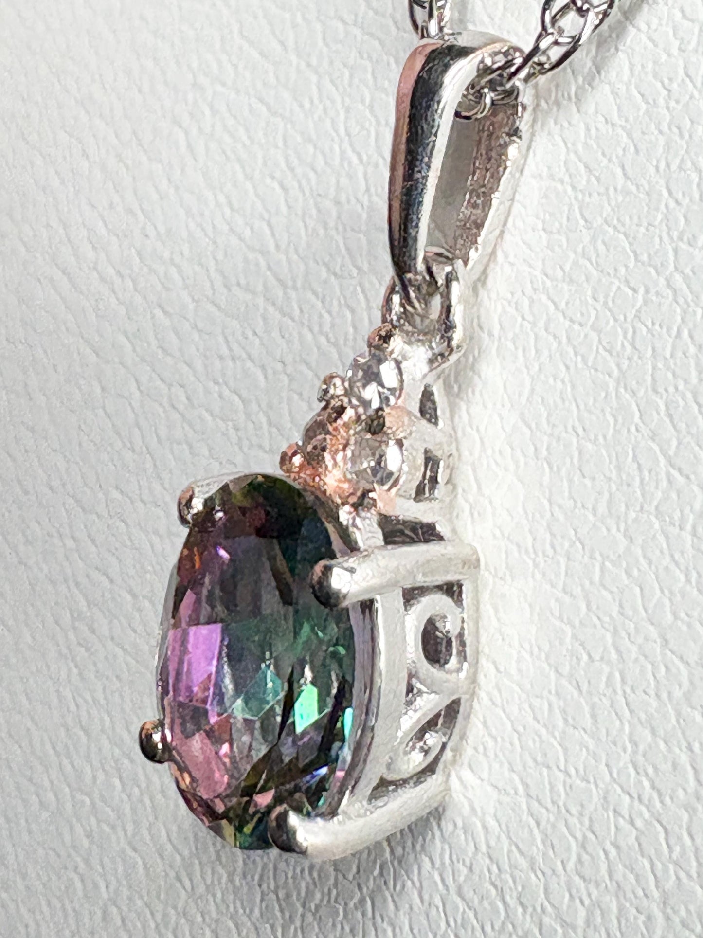 Sterling silver pendant with oval mystic topaz and lab-grown diamonds on an 18" rope chain.
