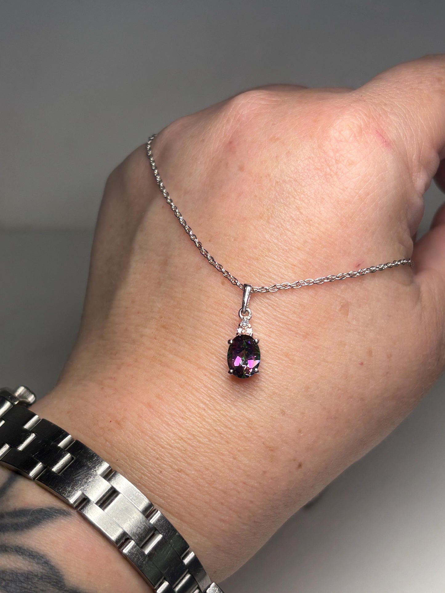 Sterling silver necklace with mystic topaz and lab-grown diamond pendant.