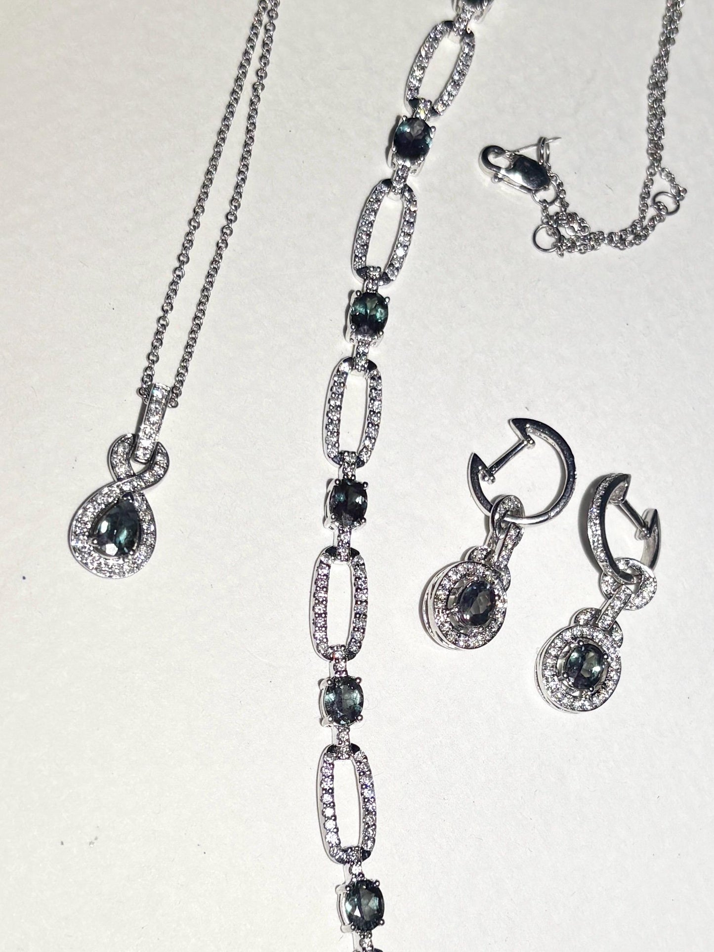 A white gold bracelet with oval alexandrite stones and diamonds.