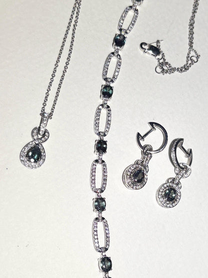 A white gold bracelet with oval alexandrite stones and diamonds.