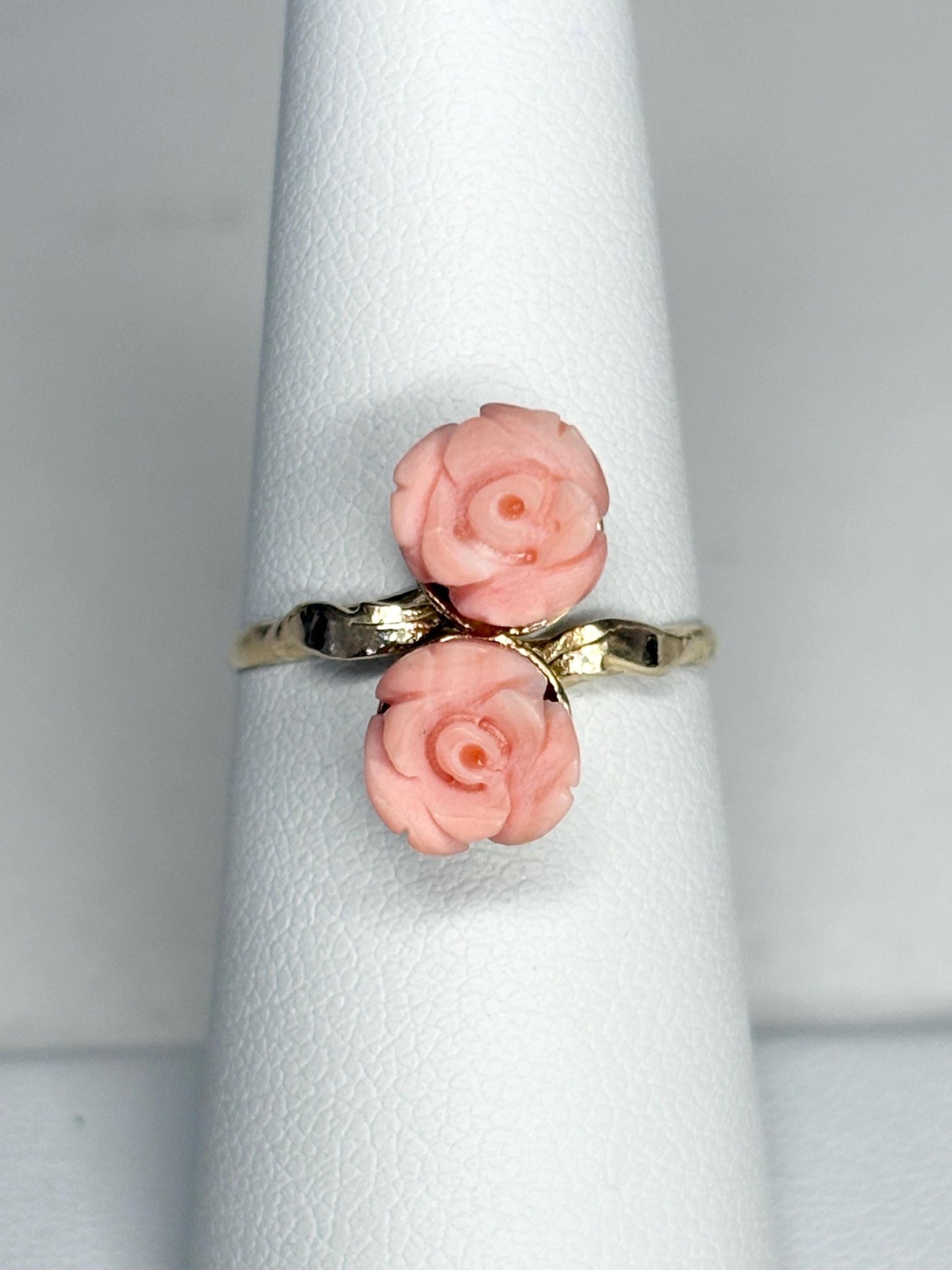Ring with two angel skin coral rose buds on a 10k gold band.