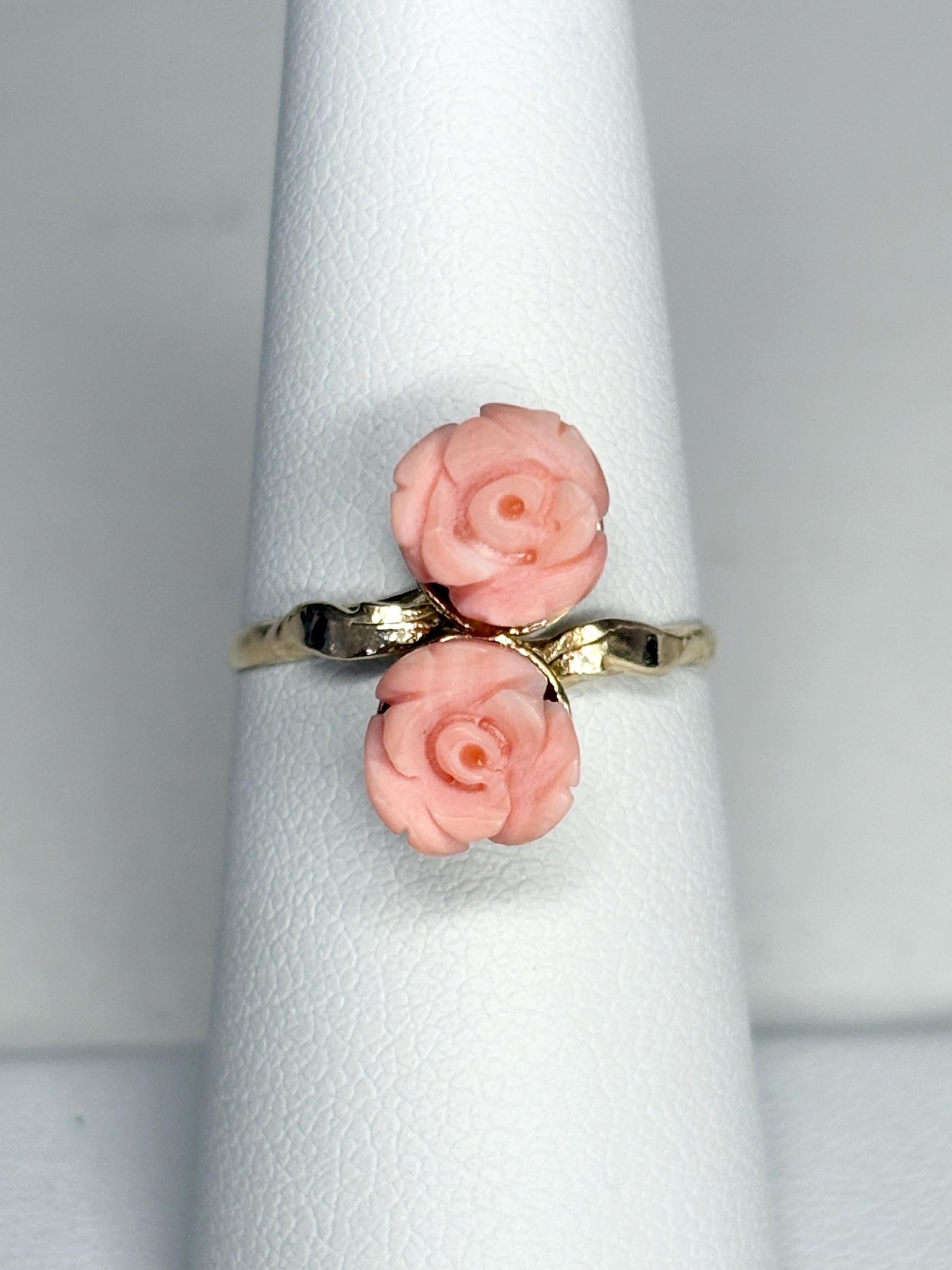 Ring with two angel skin coral rose buds on a 10k gold band.