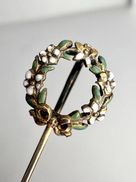 14k gold stick pin with an enameled floral wreath.