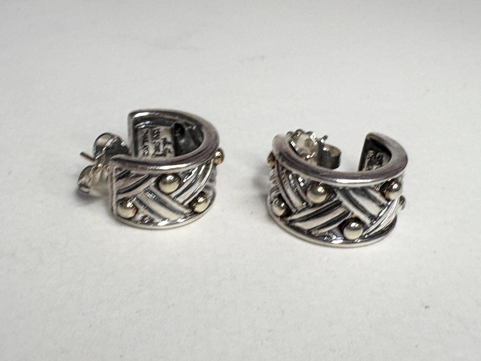 Ann King wide woven hoop earrings in 18k gold and sterling silver.